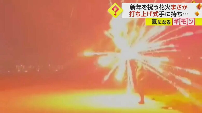 打ち上げ花火が男性の手の中で爆発する瞬間③