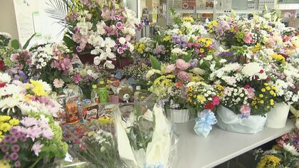 声詰まらせ 思い届くように手入れを 献花台に 585 組の花