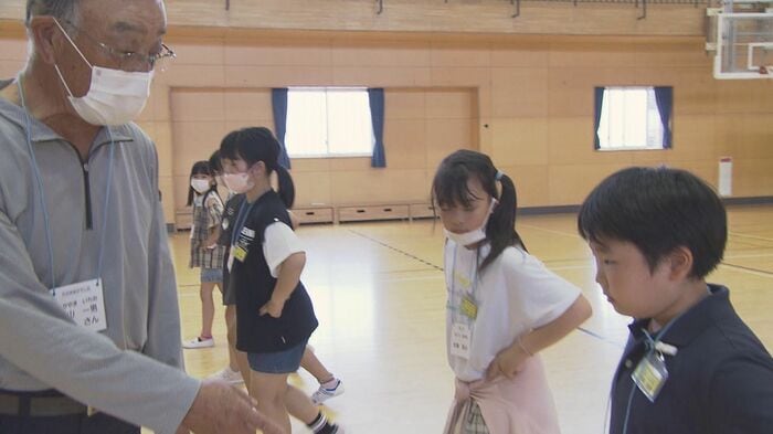 子どもたちに神楽の舞を指導する 高山一男さん