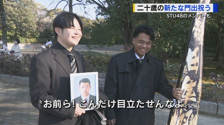 亡くなった友人の遺影と名前が書かれた“のぼり”を持つ参加者