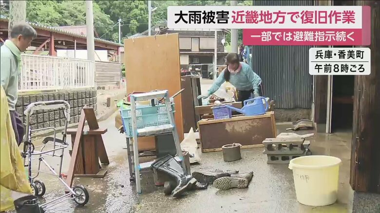 住宅が浸水し、家具を外に出す住民（兵庫・香美町）