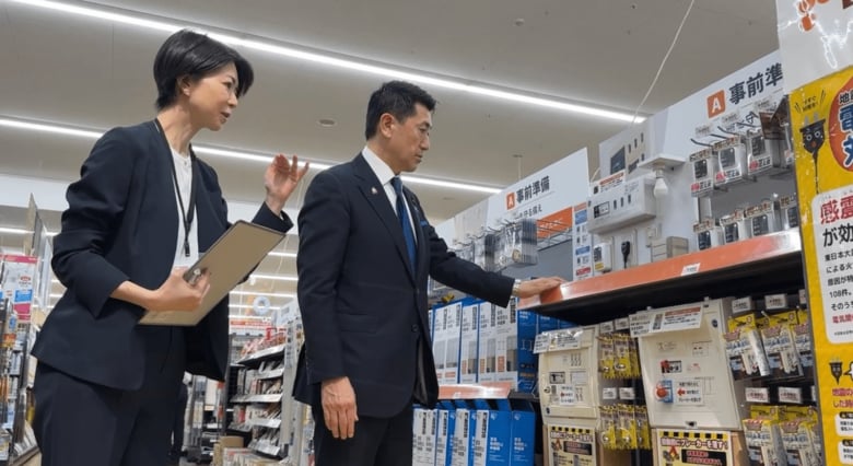赤間防災担当大臣に説明する松橋弥生DCMホールディングス執行役員（経営戦略・広報担当）