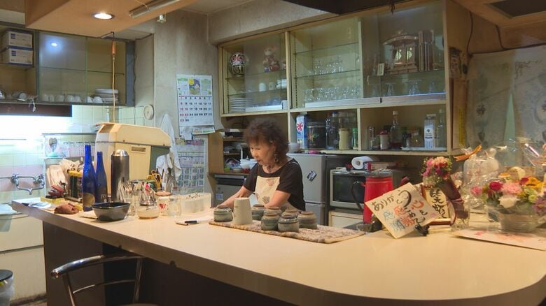 閉店後、客を送り出し、片付けをする山岸さん