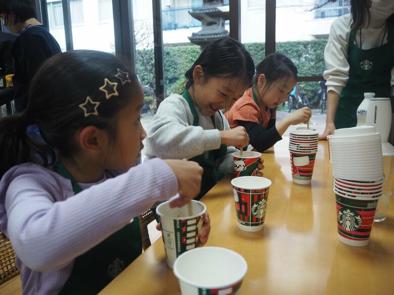 ドリンクの粉をかき混ぜる子供たち