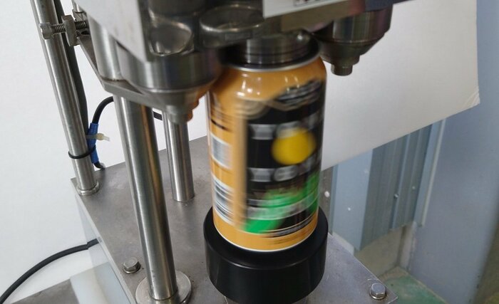「巻き締め機」で缶のフタをしめる