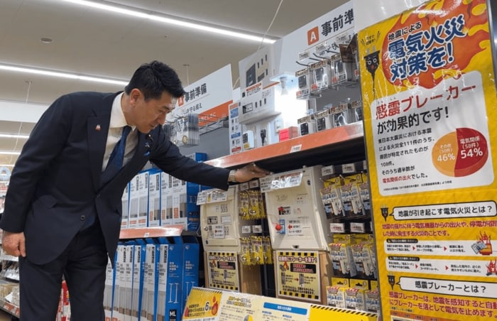 感震ブレーカーのデモ機を揺らす赤間防災担当大臣