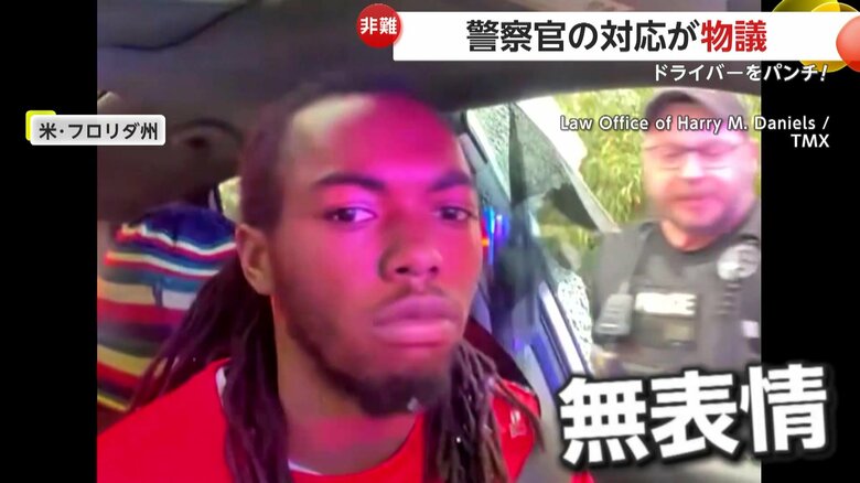 無表情でカメラ目線の男性