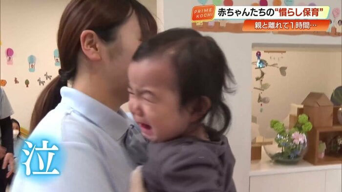 保育園の入り口で、親と離れて泣きだす赤ちゃんの表情