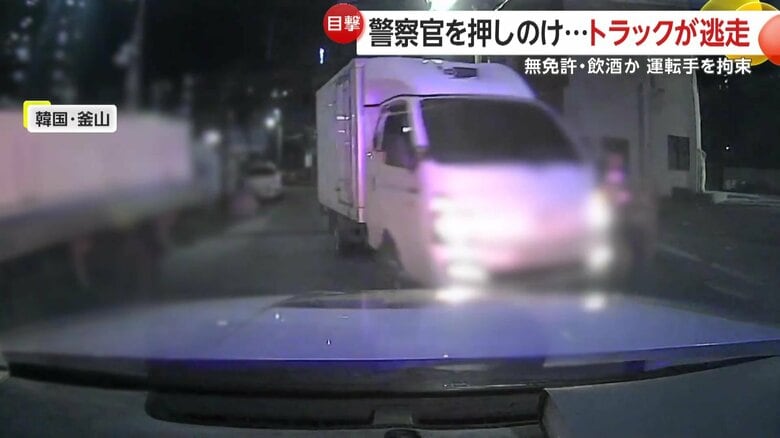 道路の真ん中に止まったトラックを発見したパトカー