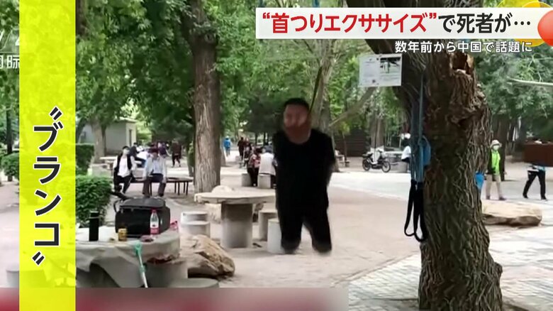 首の力だけで木につるされ体をブランコのように前後に激しく動かす男性