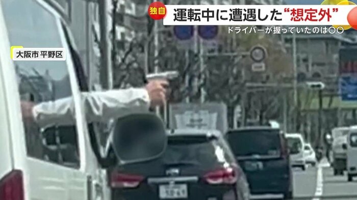 運転席から銃らしきものをのぞかせるドライバー(視聴者提供)