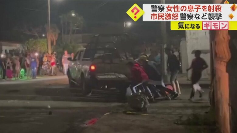 パトカーを押し倒そうとする市民