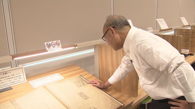 「長崎の復興の励みになったのでは」と記事を見つめる土肥原さん