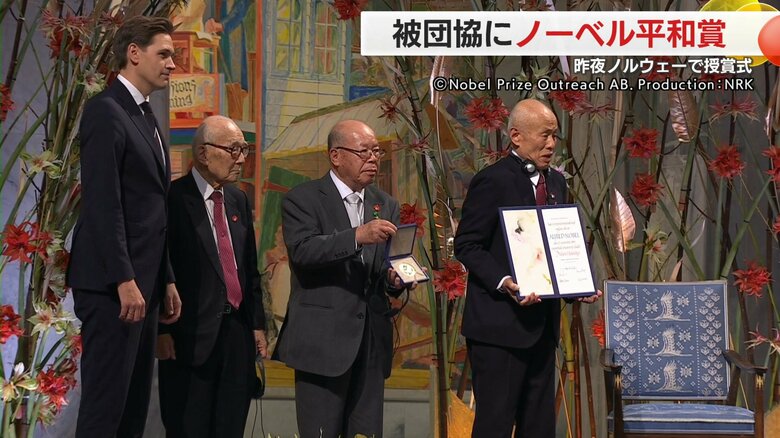 田中重光さんがメダルを受け取った