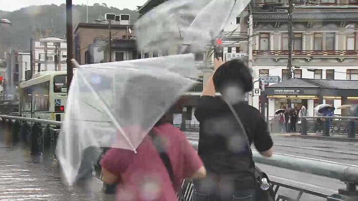 四条大橋では突風が吹き荒れ、傘が壊れてしまう人も(午前11時半ごろ)