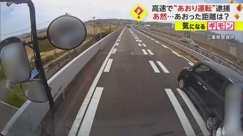 トラックを右から追い抜いていく黒い車