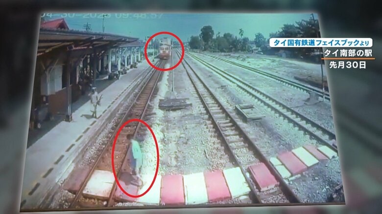 奥から迫っている電車に気がついていない