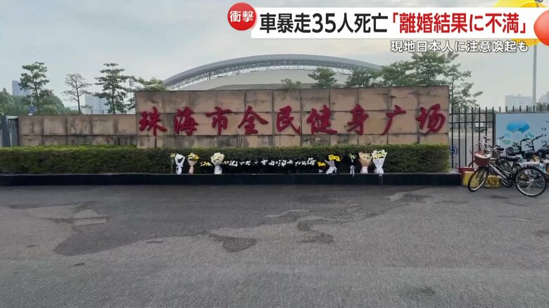 事件があった体育館入り口に手向けられた犠牲者を悼む花束