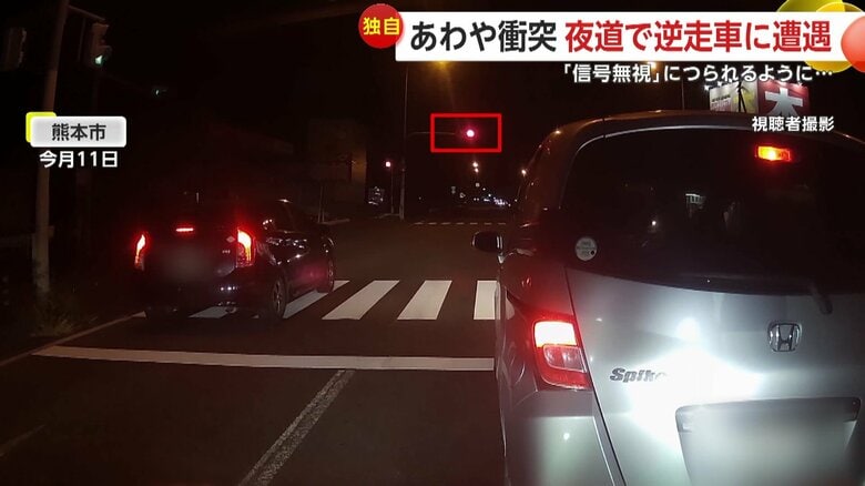 前方の信号が赤にも関わらず発進した車（11日、熊本市の交差点）