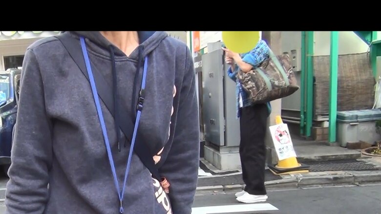 住民を取材中、背後に男性が現れた