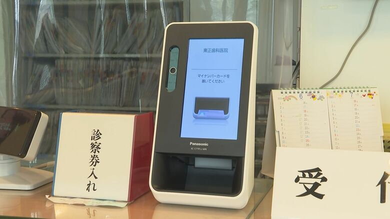 カードリーダーにマイナ保険証をかざして受け付け