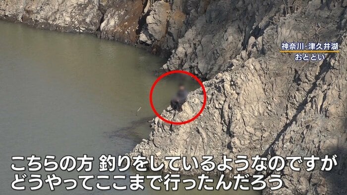 絶壁の危険な場所で釣りをする人