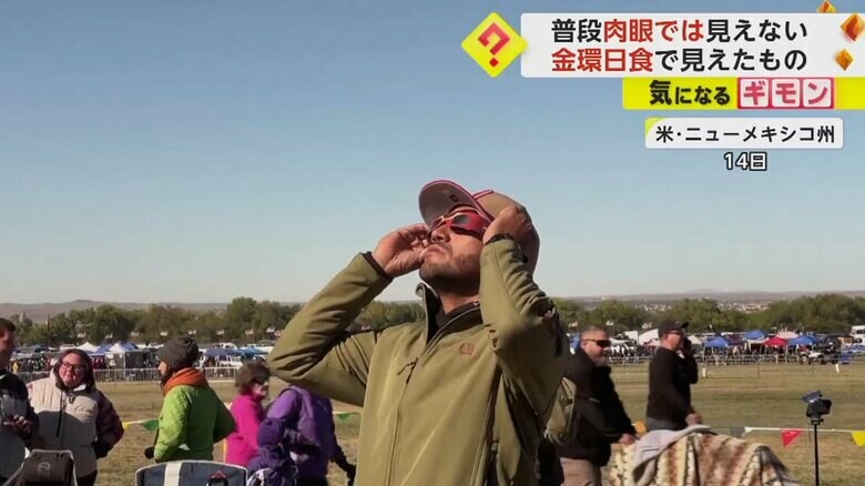 アメリカ・ニューメキシコ州の町で、金環日食の“天体ショー”が繰り広げられる空を見上げる人