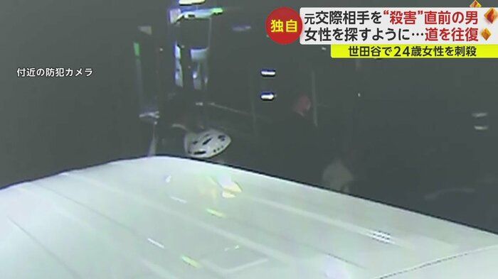 複数の警察官の間に王容疑者の白っぽい服が見える。