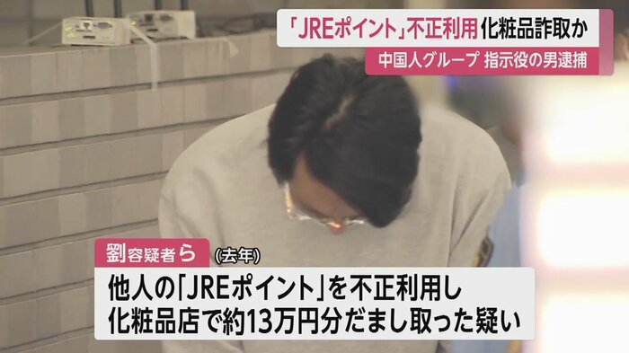 カメラの方を見た後、顔を伏せるようにしてうつむいて歩く劉容疑者(東京・亀有署 14日午前8時すぎ)
