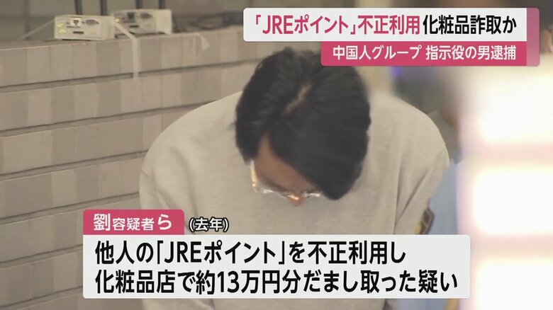 カメラの方を見た後、顔を伏せるようにしてうつむいて歩く劉容疑者(東京・亀有署 14日午前8時すぎ)