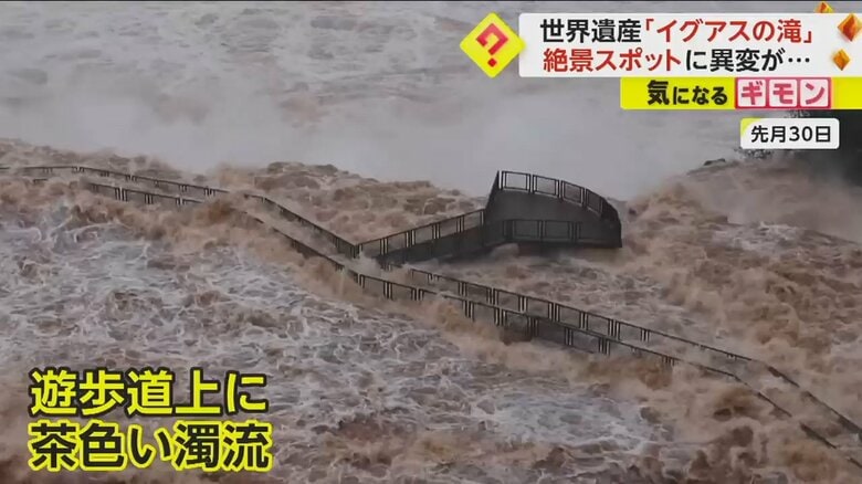 遊歩道の上に茶色い濁流が流れる様子