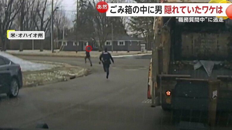 ゴミ箱から飛び出た男を追いかける警察官