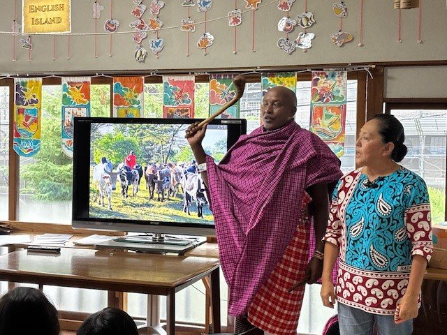 ジャクソンさんの手にはルングというこん棒が（右は永松さん）