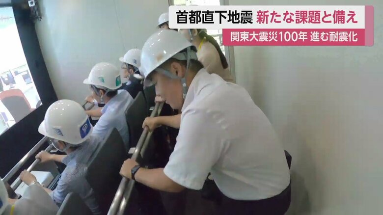 棒に捕まり、踏ん張る記者。かなり強い揺れだ